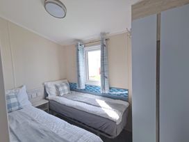 A bedroom with two beds and a window at a property
