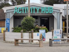 An activity hub with signage and benches outside at a recreational area