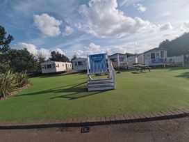 An outdoor area with caravans and seating at a holiday park