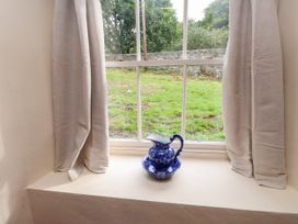 A window with a pitcher on the sill at Felin Bach in Aberdaron