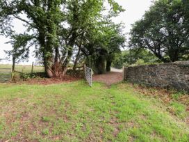 A path with a gate and trees at Felin Bach in Aberdaron