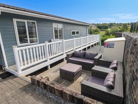 An outdoor seating area with furniture at Pleasant Valley Holiday Lodge 70 Stepaside