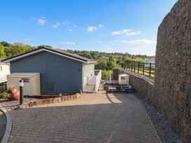 An outdoor area with a lodge and seating at Pleasant Valley Holiday Lodge 70 Stepaside