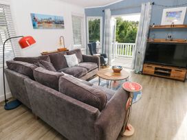 A living room with a sofa coffee table and television at Pleasant Valley Holiday Lodge 70 Stepaside