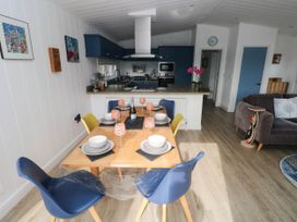 A dining area with a table and chairs at Pleasant Valley Holiday Lodge 70, Stepaside
