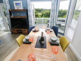 A dining room with a table set for a meal at Pleasant Valley Holiday Lodge 70 Stepaside