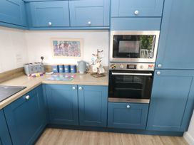 A kitchen with appliances and utensils at Pleasant Valley Holiday Lodge 70 Stepaside