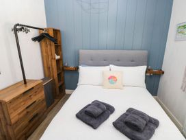 A bedroom with a bed and wooden furniture at Pleasant Valley Holiday Lodge 70 Stepaside