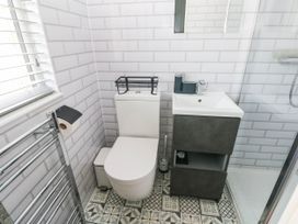 A bathroom with a toilet and sink at Pleasant Valley Holiday Lodge 70 Stepaside