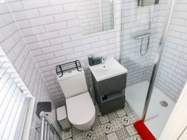 A bathroom with a toilet, sink, and shower at Pleasant Valley Holiday Lodge 70 Stepaside