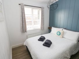 A bedroom with a bed and towels at Pleasant Valley Holiday Lodge 70 Stepaside
