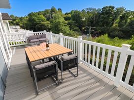 A seating area with a table and chairs on a deck at Pleasant Valley Holiday Lodge 70 Stepaside