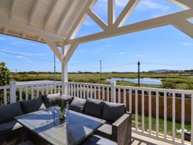 An outdoor seating area with a table and couch at 30 Southdown Avenue Weymouth