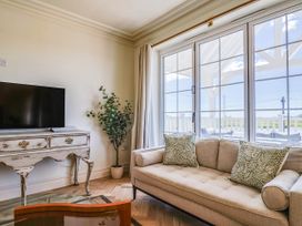 A living room with a television and sofa at 30 Southdown Avenue Weymouth