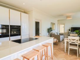 A kitchen with an island and dining area at 30 Southdown Avenue Weymouth