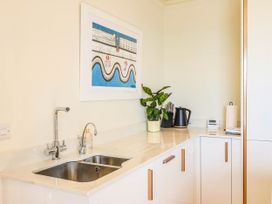 A kitchen with a sink, kettle, and plant at 30 Southdown Avenue Weymouth