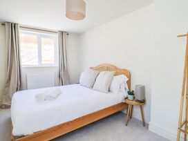 A bedroom with a bed and pillows at 30 Southdown Avenue in Weymouth