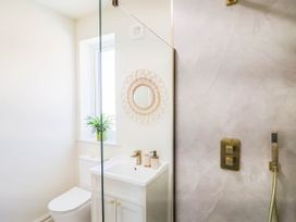 A bathroom with a toilet, sink, and shower at 30 Southdown Avenue, Weymouth