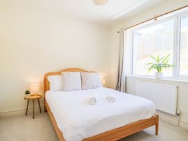 A bedroom with a bed and plant at 30 Southdown Avenue in Weymouth