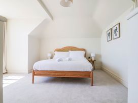 A bedroom with a bed and lamps at 30 Southdown Avenue Weymouth
