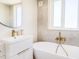 A bathroom with a sink and a bathtub at 30 Southdown Avenue in Weymouth
