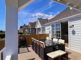 An outdoor patio with a table and chairs at 30 Southdown Avenue Weymouth