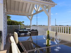 An outdoor patio with a table and sofa at 30 Southdown Avenue Weymouth