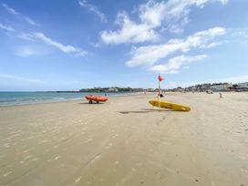 A beach with lifeguard boat and surfboard at 30 Southdown Avenue Weymouth