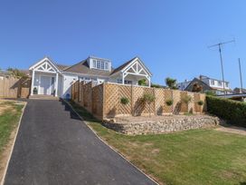 A house with a wooden fence and pathway at 30 Southdown Avenue Weymouth