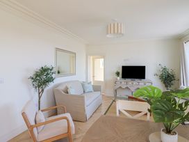 A living room with a sofa and television at 30 Southdown Avenue, Weymouth