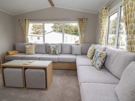 A living room with a sectional sofa and coffee table at S7 Abergele