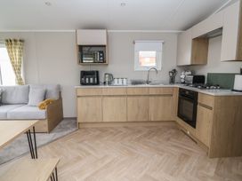 A kitchen with cabinets and appliances at S7 in Abergele