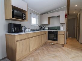 A kitchen with appliances and cabinets at S7 Abergele