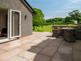 An outdoor seating area with chairs and a view of a field at Bay Bungalow
