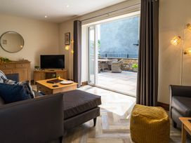A living room with a television and coffee table at Bay Bungalow 
