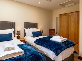 A bedroom with two beds and a wardrobe at Bay Bungalow