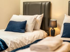 A bedroom with two beds and a lamp at Bay Bungalow