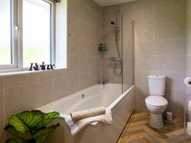A bathroom with a bathtub and toilet at Bay Bungalow
