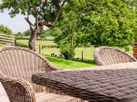 A garden with wicker chairs and table at Bay Bungalow