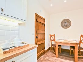 A kitchen with a table and chairs at Hillberry Cottage in Carnforth