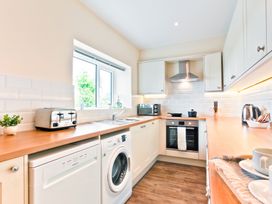 A kitchen with a sink and appliances at Hillberry Cottage in Carnforth