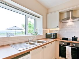 A kitchen with a sink and countertop at Hillberry Cottage in Carnforth