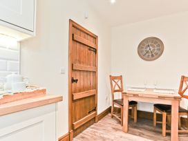 A dining room with a table and chairs at Hillberry Cottage Carnforth