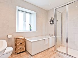 A bathroom with a bathtub and shower at Hillberry Cottage in Carnforth