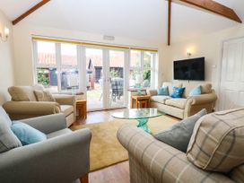 A living room with sofas and a coffee table at The Mill House Apartment
