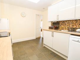 A kitchen with cabinets and appliances at The Mill House Apartment