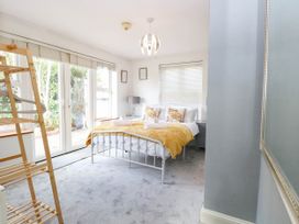 A bedroom with a bed and sliding doors at The Mill House Apartment