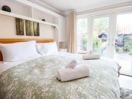 A bedroom with a bed and towels on the covers at The Mill House Apartment 