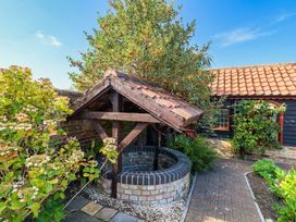 A well surrounded by plants in an outdoor area at The Mill House Apartment