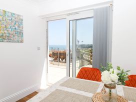 A dining room with a view of the ocean at Elberry Cove View in Paignton